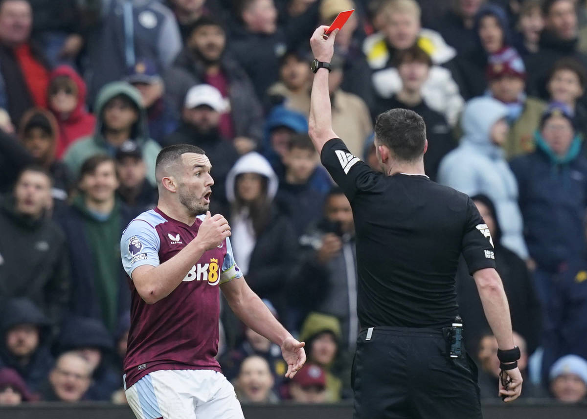 Aston Villa midfielder John McGinn pictured being shown a red card during his team's 4-0 defeat by Tottenham Hotspur in March 2024
